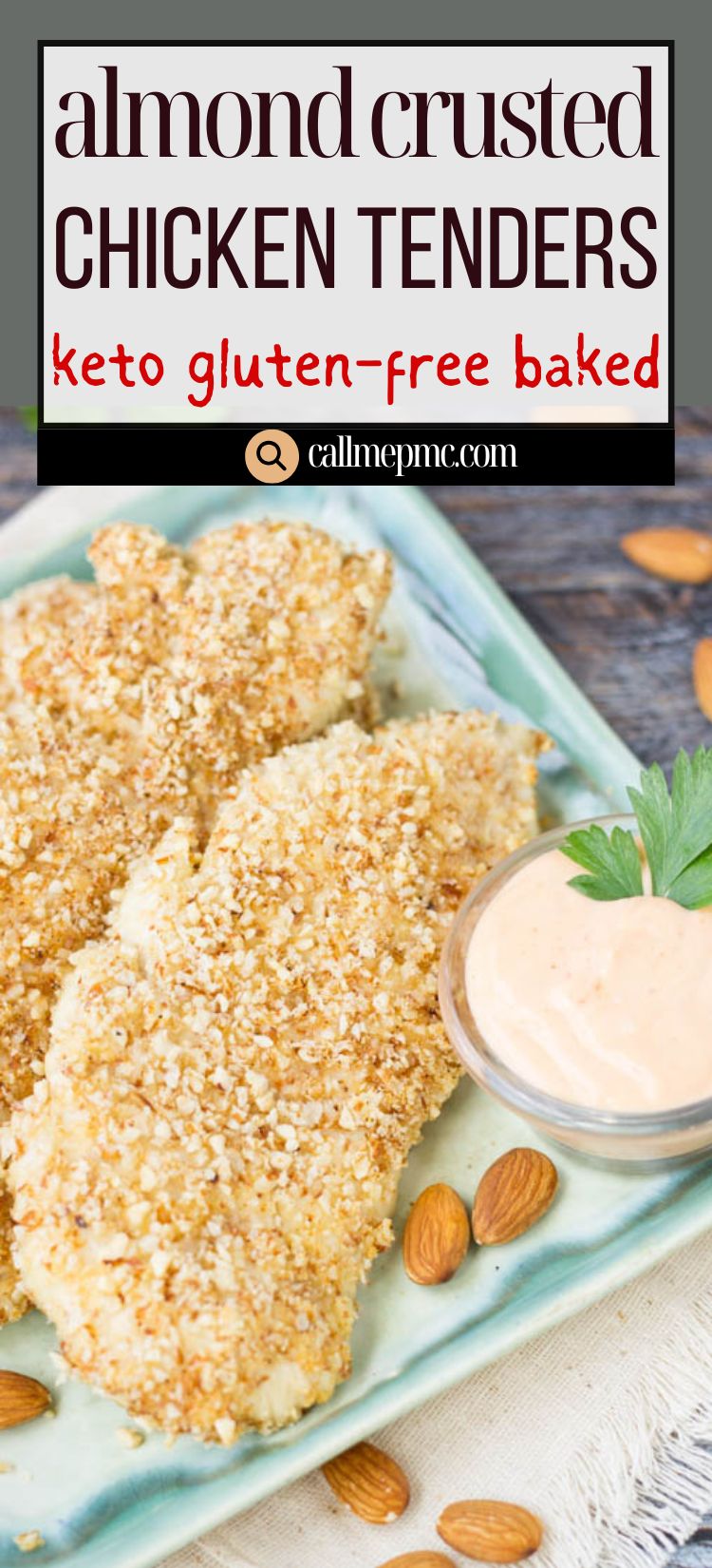 Plate of almond-crusted chicken tenders, made from a delicious Almond Crusted Chicken Tenders Recipe, served with a small bowl of dipping sauce and scattered whole almonds on a green rectangular dish.