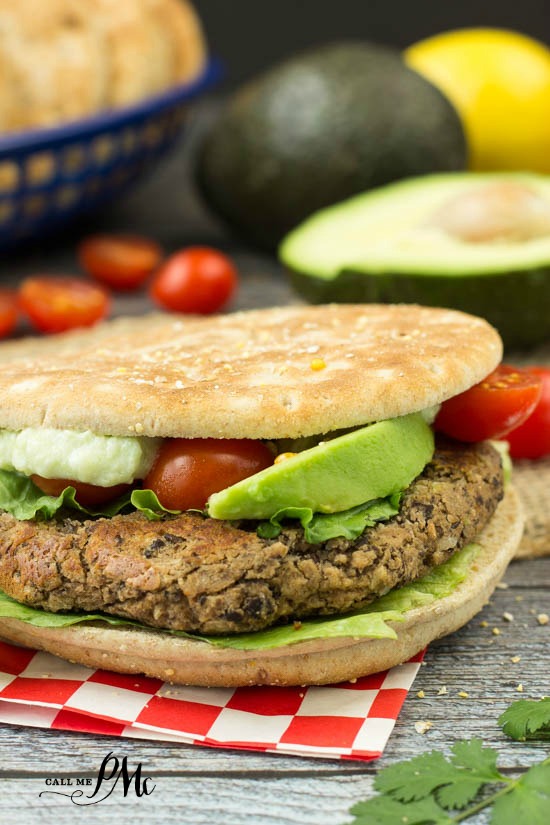 homemade black bean burger topped with avocado and tomatoes.