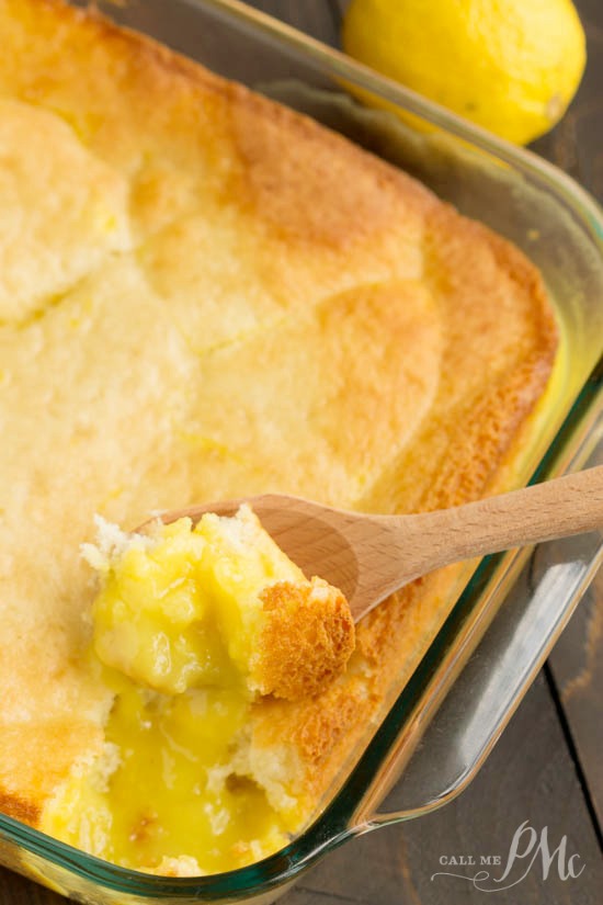 scooping a serving of lemon pudding dessert from the baking dish.