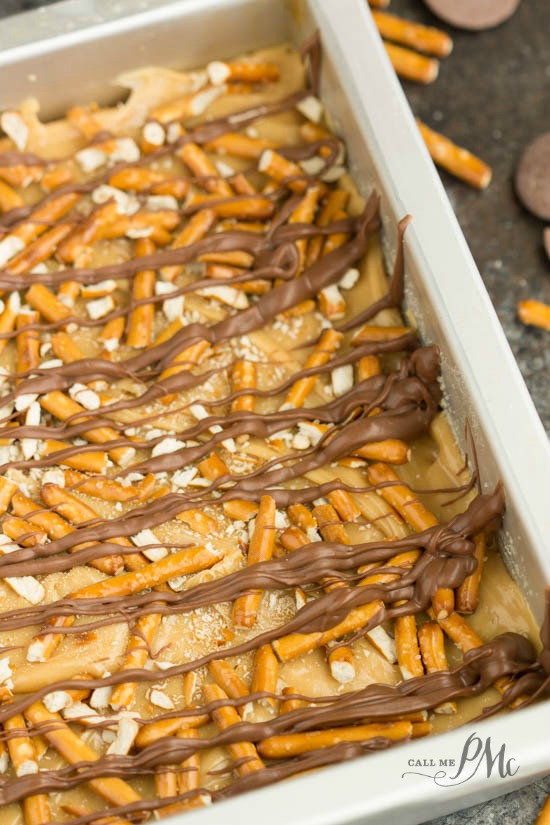 deliciously crumbly shortbread, smooth gooey caramel, salty, crunchy pretzels, and a drizzle of dark chocolate makes Crunchy Millionaire's Shortbread recipe dangerously delicious! pan of crunchy millionaire shortbread bars.