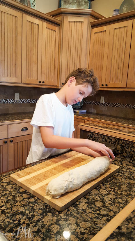 young boy making sausage pinwheels for breakfast.