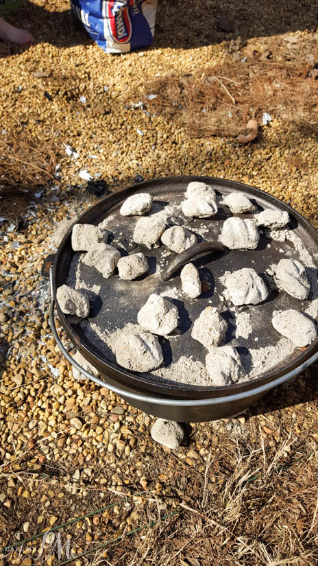 Dutch Oven Sausage Breakfast Pinwheels recipe Dutch Oven breakfast cooking on a fire.