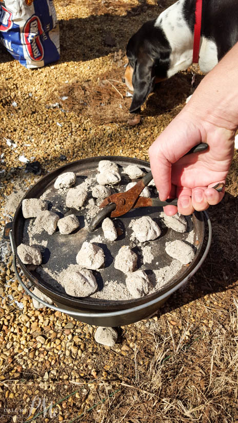 Dutch Oven Sausage Breakfast Pinwheels recipe Using pliers to remove lid from a Dutch Oven