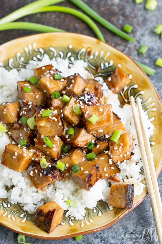 Honey Soy Pork Loin is spicy, sweet, and very simple to make. This pork is delicious and tender and will melt in your mouth. Cubes of meat over rice on a plate.