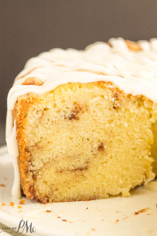 Homemade Sour Cream Cinnamon Roll Pound Cake Recipe with Cream Cheese Frosting, laced with a cinnamon swirl, this cake is buttery, yet light and is smothered in sweet cream cheese frosting. slice of frosted sour cream cake.
