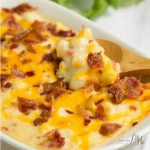 This Hominy Au Gratin casserole recipe is easy to make and super creamy. Hominy Au Gratin is an old fashioned southern staple that is a tasty and filling cheese and bacon topped side dish. Comfort food at it's best.