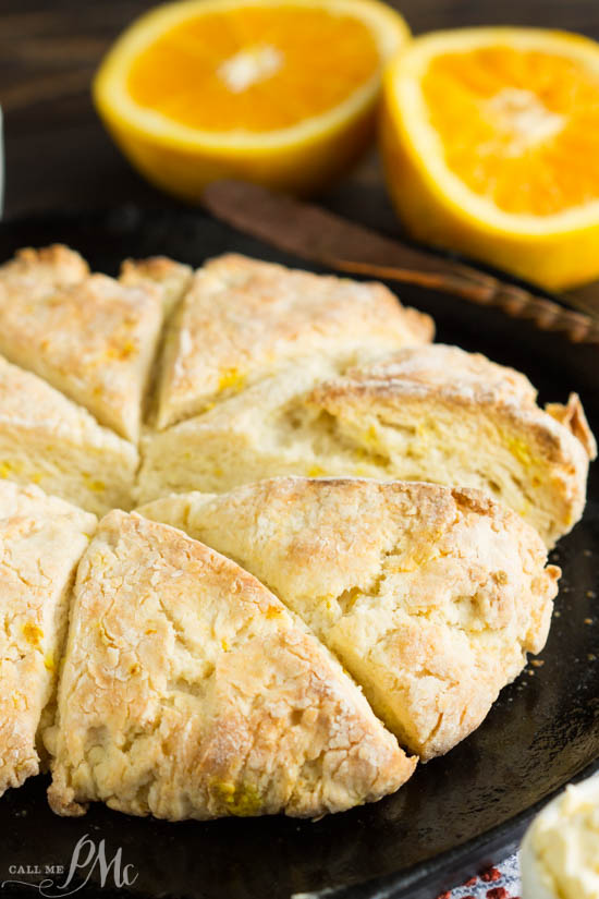 Mascarpone Cheese Scones have a subtle orange and butter flavor. The texture is soft and dense inside with flaky, crispy outside and corners. A round of bread on a skillet.