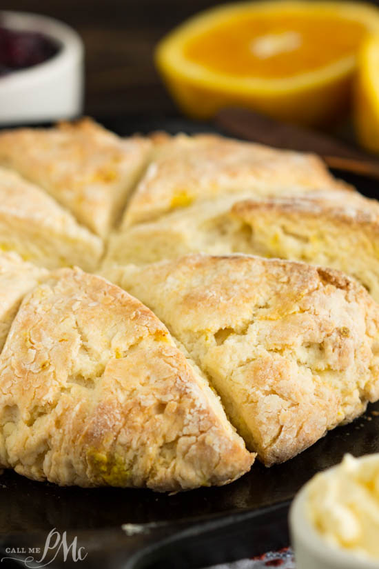 Mascarpone Cheese Scones have a subtle orange and butter flavor. The texture is soft and dense inside with flaky, crispy outside and corners. A round of bread on a skillet.