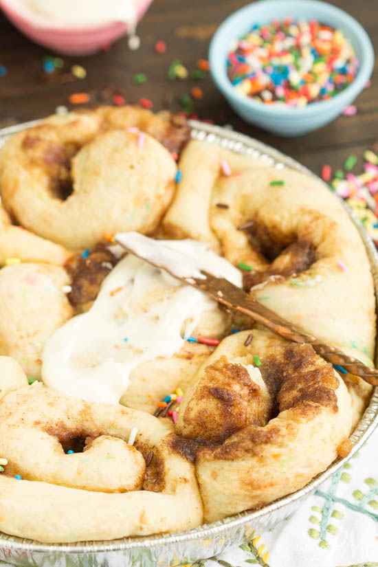 Tender and fluffy Birthday Cake Cinnamon Rolls is like having birthday cake for breakfast! Fun, festive, easy to make, and they taste heavenly! This recipe is definitely one you want to have on your breakfast roster! Pan of sweets.