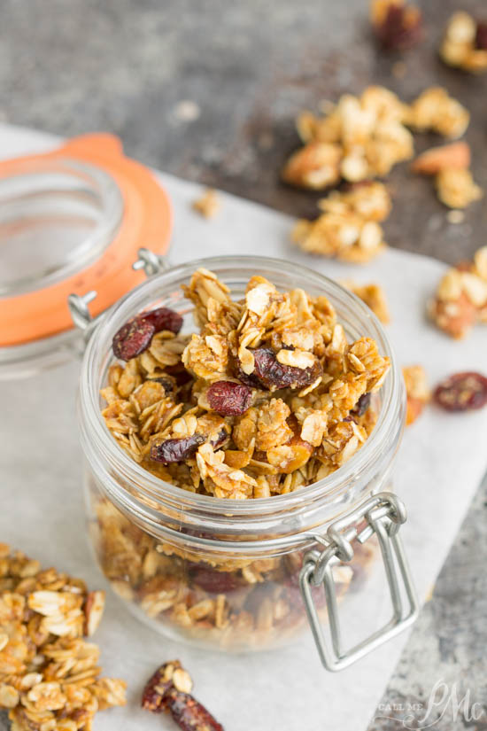 A small glass jar full of snack mix.