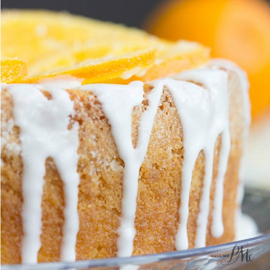 A moist and flavorful pound cake featuring orange slices and a drizzle of tangy icing.