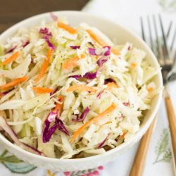 A basic cole slaw recipe, Tangy Vinegar Based Slaw is zippy and crunchy flavored with a little heat and a pinch of sweet