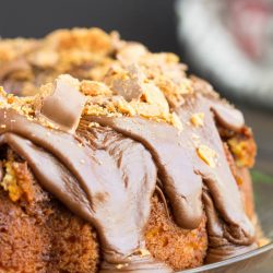 Cake Mix Butterfinger Pound Cake with Chocolate Ganache. A rich butter cake is absolutely filled with crushed Butterfinger candy bars then topped with chocolate ganache and more candy bars.