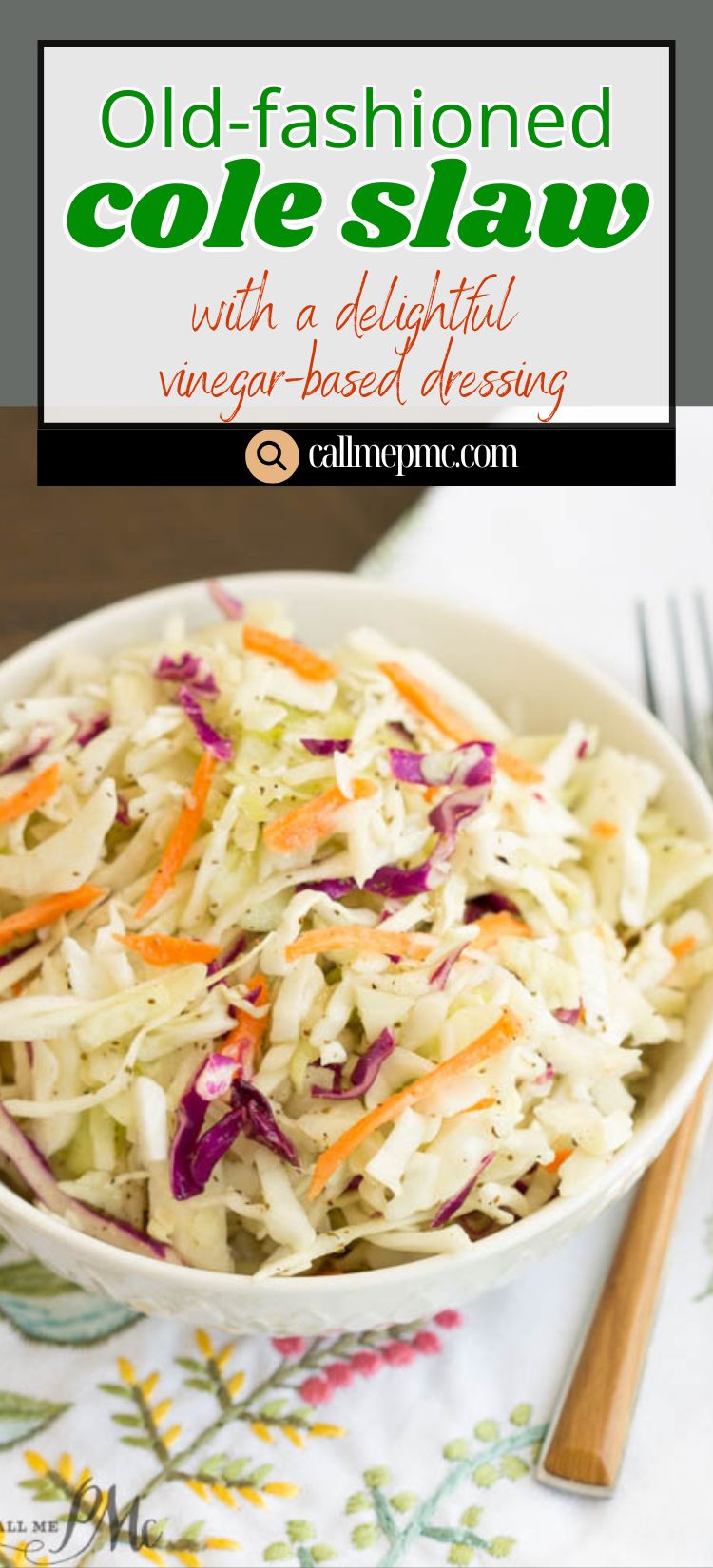 A bowl of old-fashioned Tangy Vinegar Based Slaw with shredded cabbage, carrots, and purple cabbage sits on a floral-patterned tablecloth.