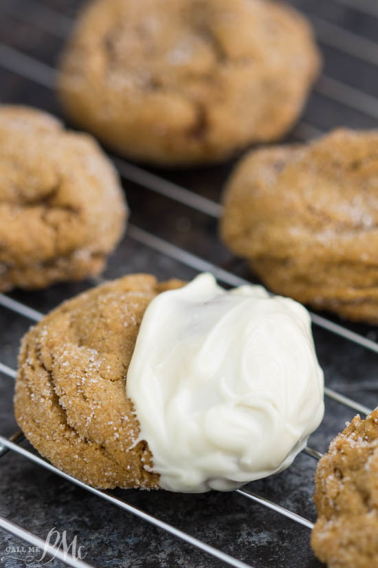 Perfectly flavored, Blue Ribbon Chewy Molasses Ginger Cookies recipe have a snap from the sugar on the outside but are luscious and chewy without being cakey on the inside. White chocolate decorated biscuits on a wire rack.
