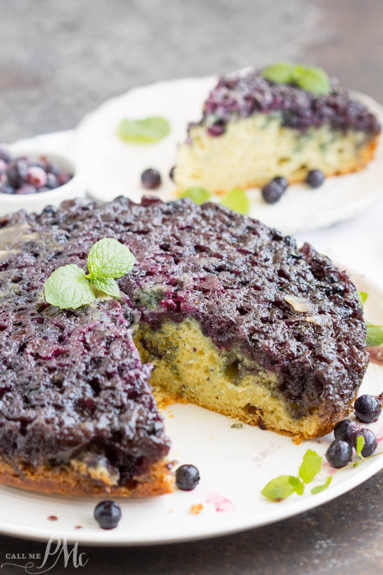 Homemade Blueberry Upside-down Cake is unbelievably good. Blueberries and a caramel glaze ooze down into the tender yellow cake making it moist and decadent. This cake recipe has quickly become one of my all-time favorites! Whole cake with slice missing.