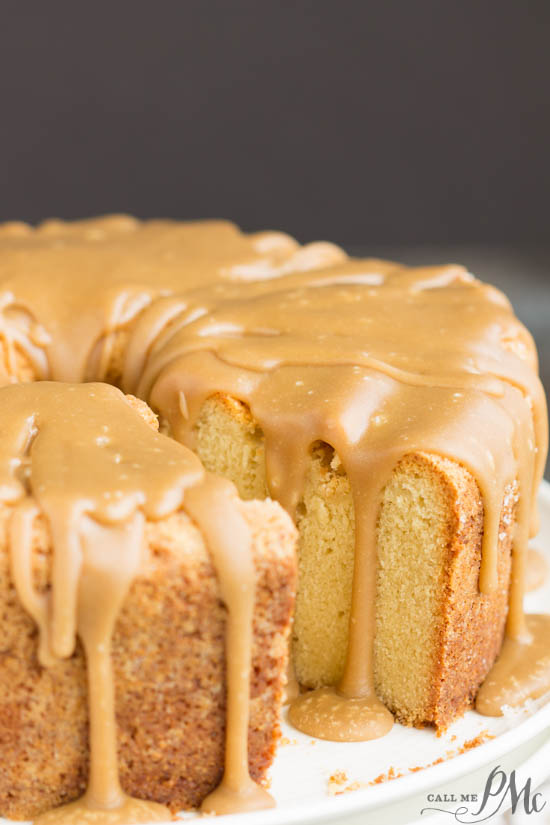 Pound cake with caramell icing dripping off and one slice missing from full cake.