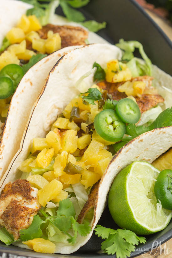 Jerk fish taco on a plate with pineapple salsa.