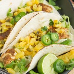 Spicy, sweet, and super flavorful, Caribbean Jamaican Jerk Fish Tacos with Lime Crema, are easy, delicious, and bursting with a complex mix of flavors.