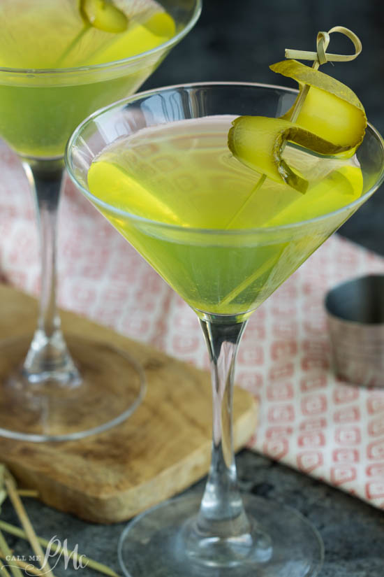 Dill pickle martini in martini glass with pickle garnish.