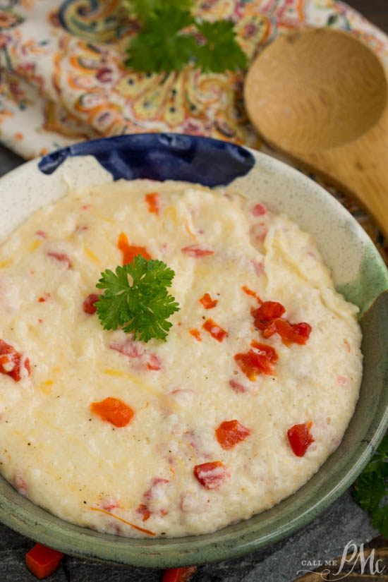 Pimento Cheddar Cheese Grits Recipe is a perfect side dish when entertaining at brunch. They are smooth, creamy, cheesy, and studded with flavorful pimentos.ย Bowl of creamy food with red peppers.