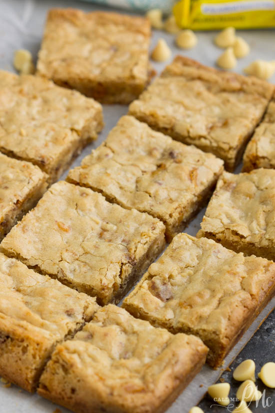 Butterfinger Blondies recipe, these soft and chewy blondies are loaded with white chocolate and rich peanut buttery Butterfingers!ย I'm a big believer in packing blondies to the max with chocolate goodness! Butterfinger Blondies
