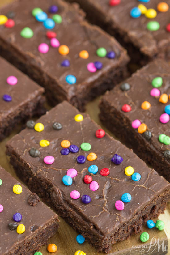 Rich, fudgy & covered with bright little sprinkles, these homemade Copycat Little Debbie Cosmic Brownies Recipe taste just like those fudgy lunchbox treats! Little Debbie Cosmic Brownies on a wood board.