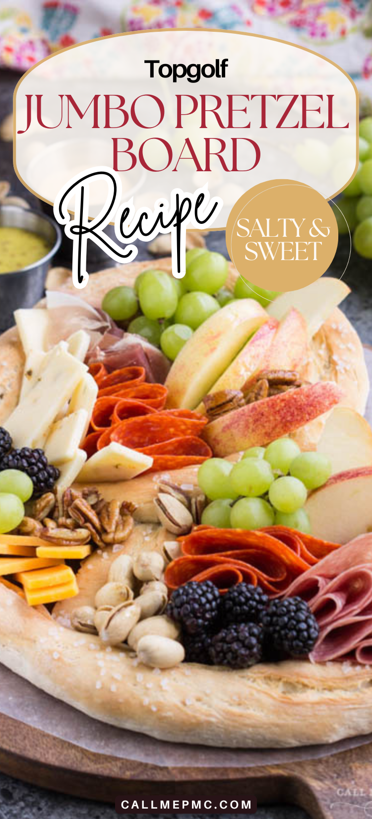 A large Topgolf Pretzel Board Recipe features assorted cheeses, meats, apple slices, grapes, blackberries, nuts, and a small bowl of dip on the side.