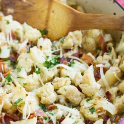 Sautéed Cauliflower and bacon oven baked in a cheesy creamy garlic sauce topped with bubbling mozzarella and parmesan cheese!