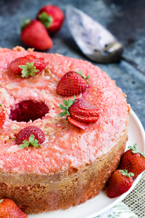 Indulge in a mouthwatering cake with fresh strawberries on a plate.