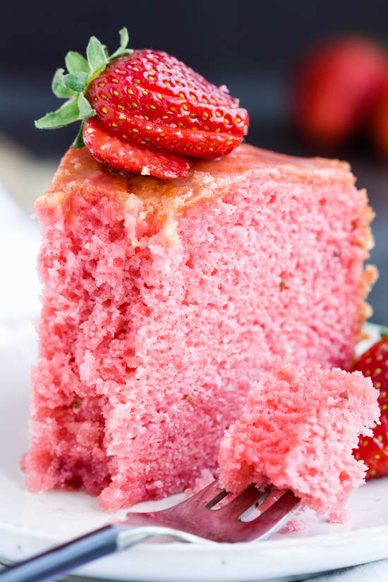A slice of strawberry cake on a plate, perfect for dessert.