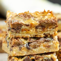 Pecan Shortbread Toffee and Rolo Magic Cookie Bars, whether you call them Magic Cookie Bars, Hello Dolly Bars, or Seven Layer Bars this ooey, gooey dessert recipe is sure to please! They are always a crowd-pleaser and always hit the spot!