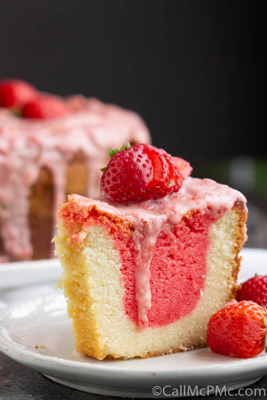 Strawberry & Cream Pound Cake with Jello is a super moist pound cake with two very special flavors. The favorite combination of strawberries and cream is put together in a unique way to make an extraordinary pound cake! A slice of strawberry cream pound cake on a plate.