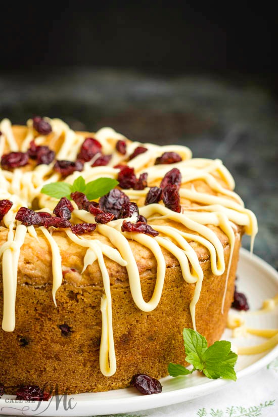 Holiday Greek Yogurt Cranberry Pound Cake is tender, buttery, and spiked with tart cranberries. Perfect for the holidays, this dessert is festive, fluffy, and delicious.