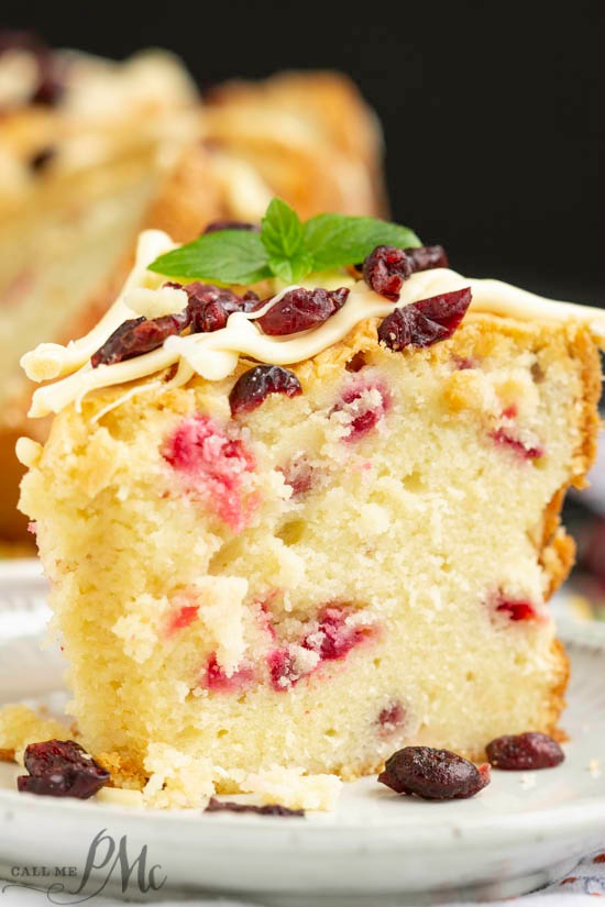 Holiday Greek Yogurt Cranberry Pound Cake is tender, buttery, and spiked with tart cranberries. Perfect for the holidays, this dessert is festive, fluffy, and delicious.