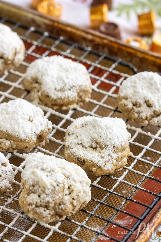 Hidden Rolo Snowball cookies, a hidden Rolo chocolate and caramel candy make this cookie a sweet surprise. This is a fun cookie recipe alternative. #cookie #chocolate #caramel #dessert #recipe desserts on a wire rack