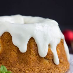 A moist Best Sweet Potato Pound Cake with Cream Cheese Frosting is highlighted by a cinnamon, cloves, and topped with cream cheese glaze.