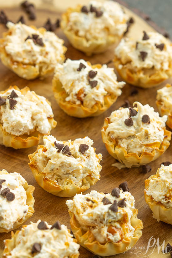No-Bake Butterfinger™ Cheesecake Tarts recipe is a creamy no-bake pie with Butterfinger candy in a pre-made tart shell. #pie #recipe #dessert Butterfinger Cheesecake on display.