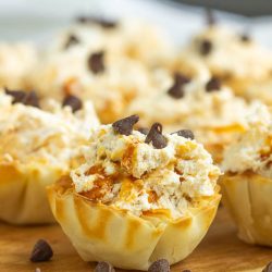 No-Bake Butterfinger™ Cheesecake Tarts recipe is a creamy no-bake pie with Butterfinger candy in a pre-made tart shell.