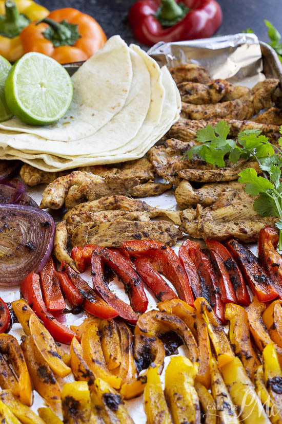 Healthy 20 Minute Chili Lime Sheet Pan Chicken Fajita Recipe is an easy weeknight dinner staple. Crispy veggies, tender chicken and shrimp are seasoned with chili pepper and lime juice then served with healthy tortillas. Sheet Pan Chicken Fajita