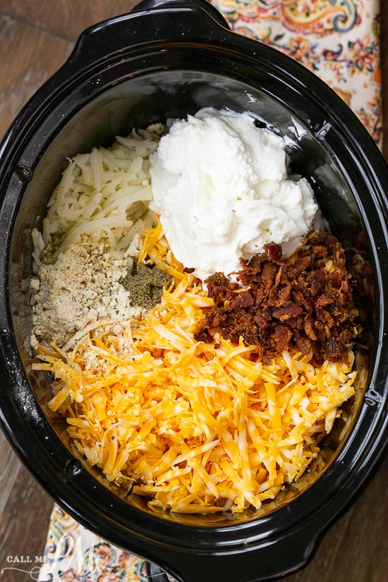 Crock Pot Crack Hash Brown Potatoes, the quintessential comfort food gets an easy and delicious make-over with the addition of Ranch seasoning and bacon. #bacon #cheese #hashbrowns #slowcooker crock full of ingredients