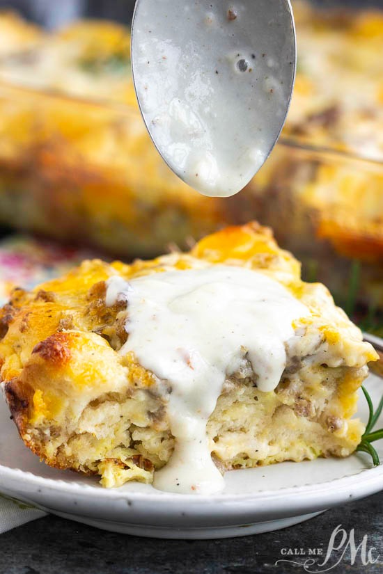 This easy Sausage Gravy Biscuit Bubble Up Casserole is loaded with delicious biscuits baked in a flavorful egg and sausage scramble and topped with gravy! A slice of savory breakfast bubble up casserole topped with creamy white gravy sits invitingly on a white plate.
