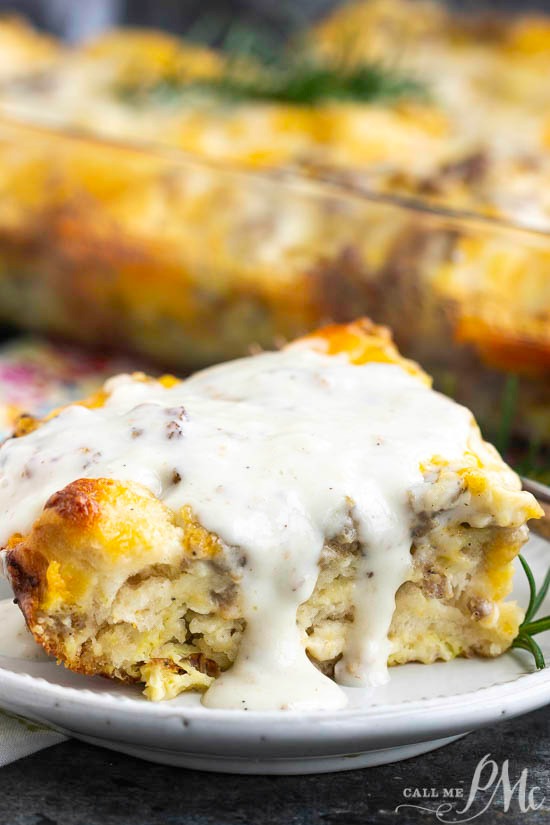 This easy Sausage Gravy Biscuit Bubble Up Casserole is loaded with delicious biscuits baked in a flavorful egg and sausage scramble and topped with gravy! A slice of savory casserole topped with creamy white gravy sits invitingly on a white plate.