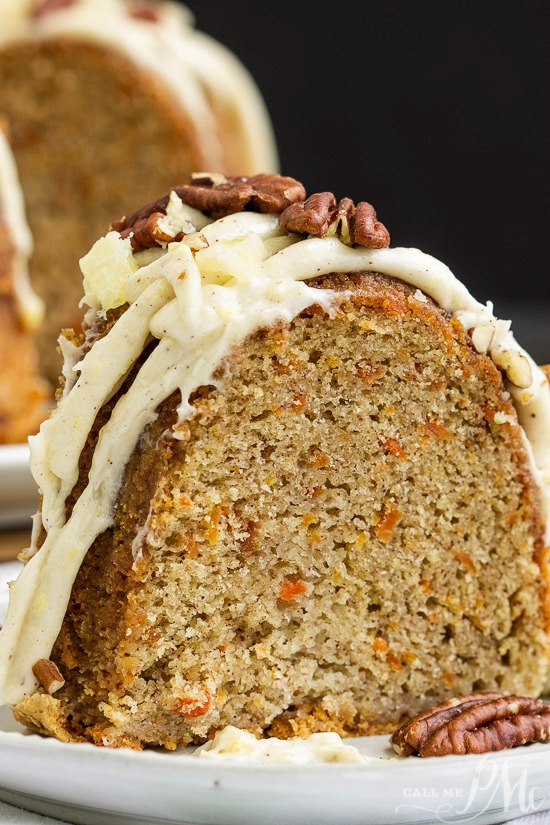 This incredibly tender and moist Blue Ribbon Roasted Carrot Pound Cake with Pineapple Mascarpone Frosting Recipe is the best carrot cake you'll ever make! #cake #poundcake #carrotcake #Eastercake #springcake Carrot Pound Cake A slice of carrot pound cake topped with pineapple mascarpone frosting, garnished with pecans, rests invitingly on a white plate.