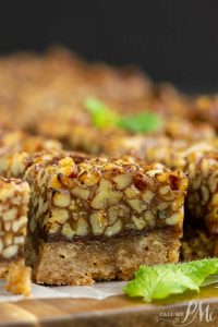 Pecan squares on a cutting board with mint leaves.