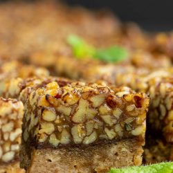 Pecan squares on a cutting board with mint leaves.