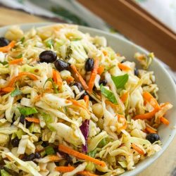 Tex Mex Coleslaw is packed with flavor and perfect for summer cookouts. It also adds a nice crunch to tacos, fajitas, and wraps.