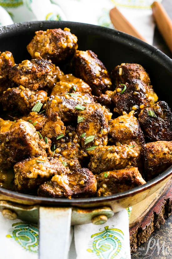 Stove Top Cajun Butter Chicken Bites are easy to prep, ready in minutes, and have a bold buttery garlic flavor. #recipe #chicken #stovetop Chunks of meat in a skillet.