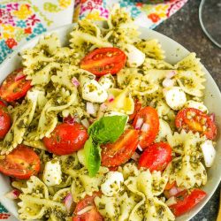 Bowtie Pesto Pasta Salad combines Caprese salad and basil pesto with pasta for a quick, easy, and delicious pasta salad.