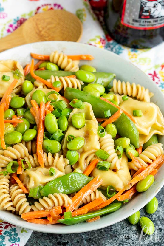 A summer classic with a twist, Potsticker Pasta Salad is loaded with healthy vegetables and topped with toasted sesame dressing. #sesameseed #salad #pasta #pastasalad #potsticker #potstickersalad #edamame #vegetables #healthy #easy #recipes #cold